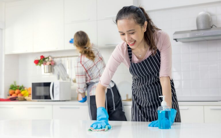 happy cleaners doing home cleaning in Singapore